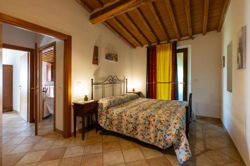 a bedroom with a bed and a table in a room at San Lorenzo Agriturismo in Buonconvento