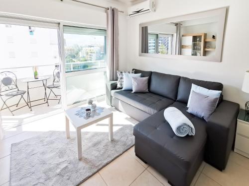 a living room with a couch and a table at Apartment Panorama Rocha Capri in Portimão