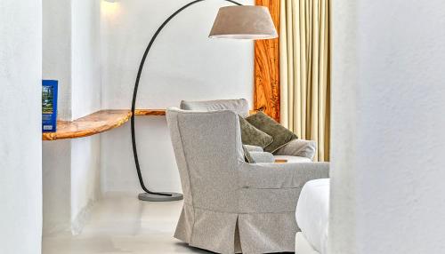 a floor lamp sitting next to a chair and a lampost at Villa Ravino Secret Retreat in Ischia