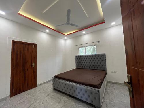 a bed in a room with a ceiling at Reet Farms in Noida