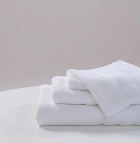 a pile of white towels sitting on a table at Pulse in Völs