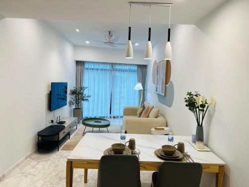 a living room with a table and a couch at Eaton Residence KLCC - KL SUITE in Kuala Lumpur