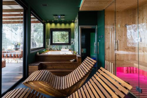 two wooden benches in a bathroom with a tub at Masseria Santa Teresa in Monopoli