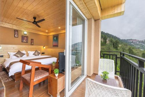 a bedroom with a bed and a balcony at The Kufri Retreat I Vacations I Conference I MICE I Family Events I Open Air Terrace I Sky Bonfire I Wooden Rooms With Pvt Balconies I by Exotic Stays in Shimla