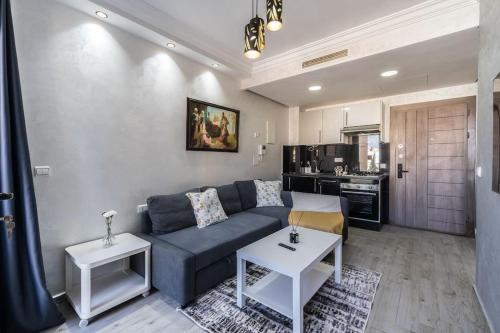 a living room with a couch and two tables at Chic Apartment Cosy Stay in Casablanca