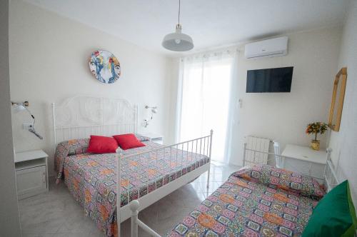 Postel nebo postele na pokoji v ubytování Casa Gita a Tindari