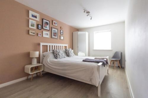 a bedroom with a white bed and a window at Spacious Central Family Apartment in London