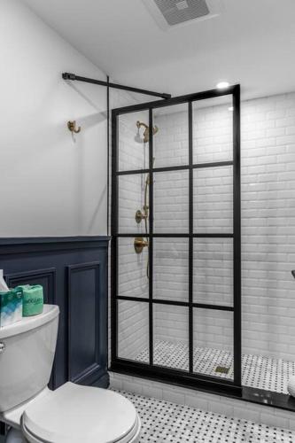 a bathroom with a toilet and a glass shower at DTWN Bangor, Historic Hotel, Coffee Shop in building, Room # 105 in Bangor