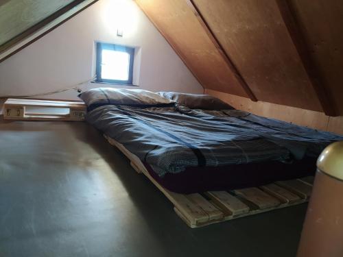 a small bed in a room with a window at Apartmán u lesa u Adršpachu in Jívka