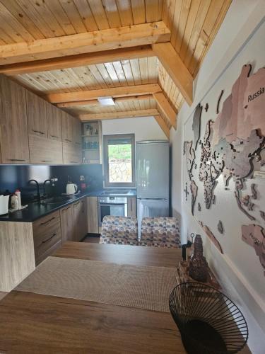 a kitchen with wooden ceilings and a counter top at Vikendica IVA in Pale