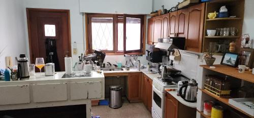 a kitchen with a lot of clutter on the counters at @embajadapichincha in Rosario