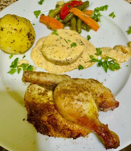 a plate of food with chicken and vegetables on it at Riad Sahara Stars Dades in Boumalne