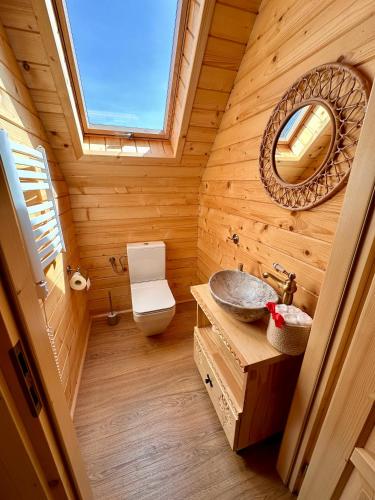 a wooden bathroom with a sink and a mirror at Sielska Chata Beskidy in Zawoja