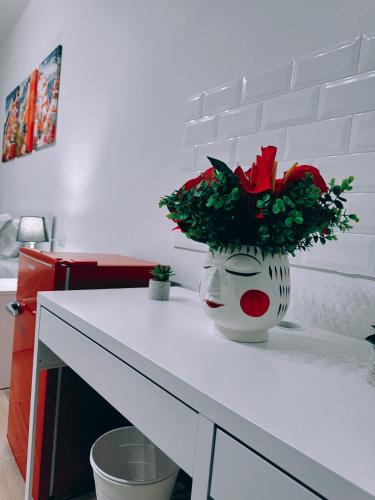 a vase with a mask on top of a counter at EllePì Rooms in Naples