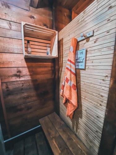 a wooden bathroom with a towel hanging on the wall at Fain in Lunca Bradului