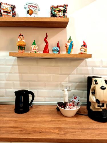 a counter with a coffee maker and a bowl of cookies at EllePì Rooms in Naples