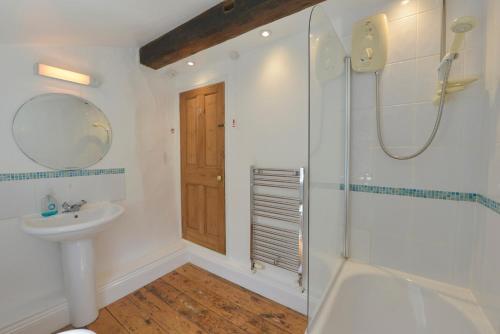 a bathroom with a shower and a sink at April Cottage in Coverack
