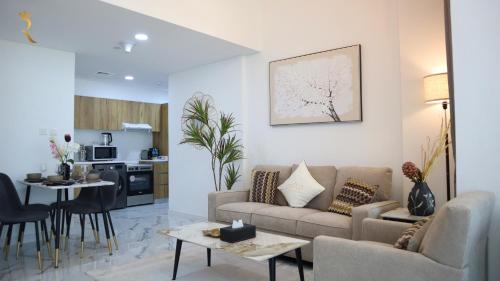 a living room with a couch and a table at 2BR Serene Luxury Retreat - Stylish Getaway in Abu Dhabi