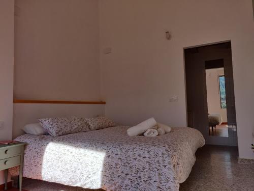 un dormitorio con una cama con dos animales de peluche en Naturaleza en casa para grupos, descansa y disfruta, en Ayelo de Rugat
