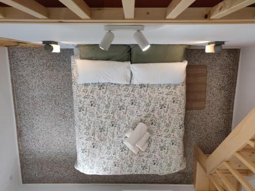 an overhead view of a bed with two pillows at L'Almàssera - Chimenea y montaña para grupos en Aielo de Rugat in Ayelo de Rugat