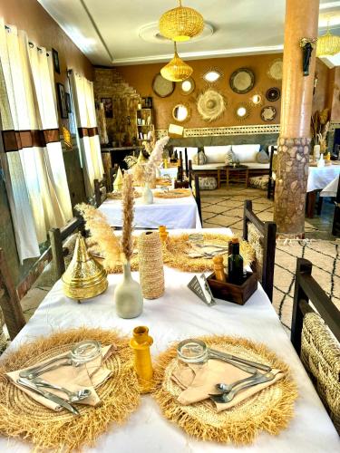 a table with plates and napkins on top at Riad Sahara Stars Dades in Boumalne