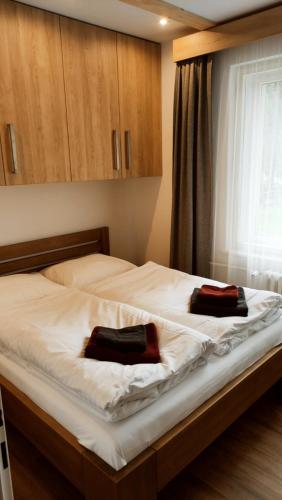 a bedroom with a bed with two towels on it at Apartmány u Holubů Na náměstí in Rožnov pod Radhoštěm