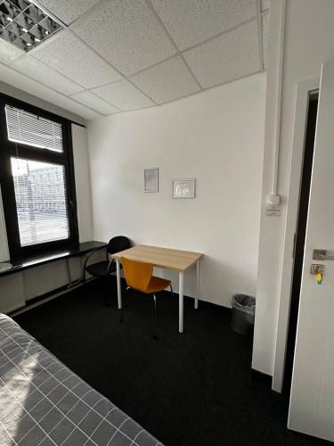 an office with a desk and a table and a window at Aleja "Solidarności" in Warsaw