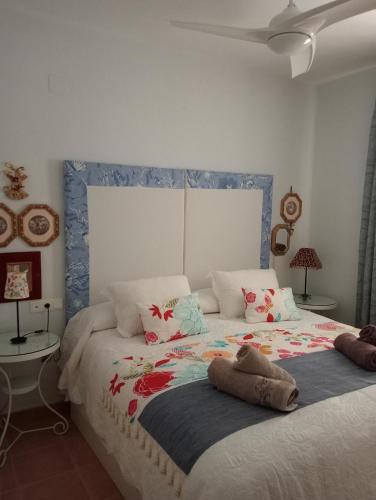 a bedroom with a large bed with flowers on it at Casa coqueta con jardin in La Redondela