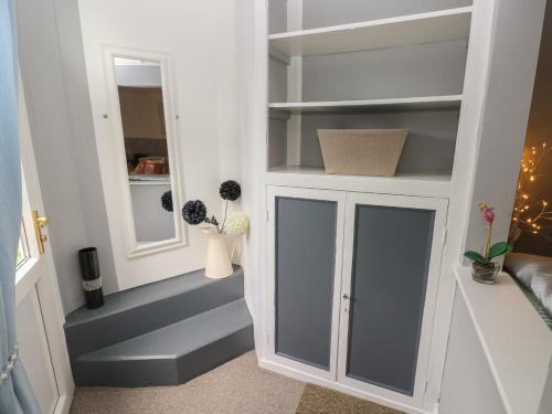 a room with a white cabinet with glass doors at Llys-Yr-Onnen in Carmarthen