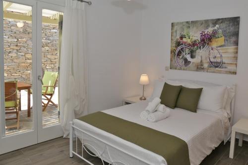 a bedroom with a bed with towels on it at Anchorage Andros Villa in Andros