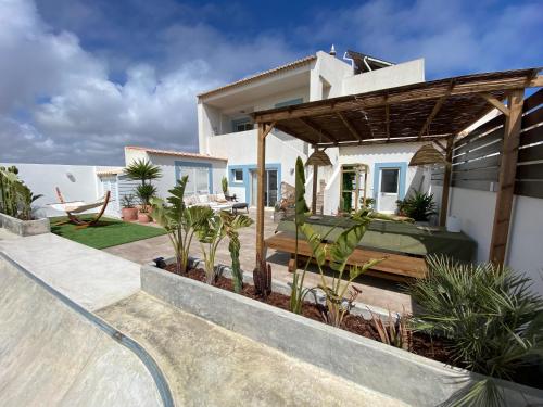 a villa with a swimming pool and a house at Casa Biota in Sagres