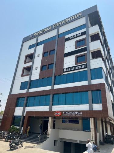 a large building with a sign on the front of it at Hotel Pasupala Inn in Anantapur
