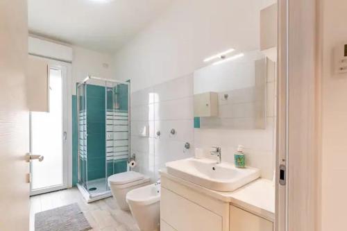 a bathroom with a sink and a toilet and a shower at Emme Apartment IUN (Q8410) in Cagliari