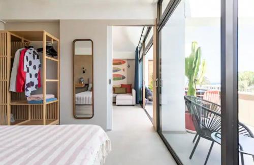 a bedroom with a bed and a room with a mirror at Ocean blue 405 in San Bartolomé