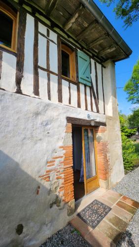 a building with a door on the side of it at Gites Souleilla de la Nine in Canens