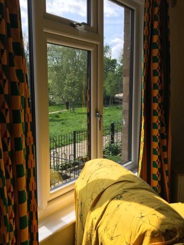 a bedroom with a window with a view of a yard at River Airebnb in Bradford