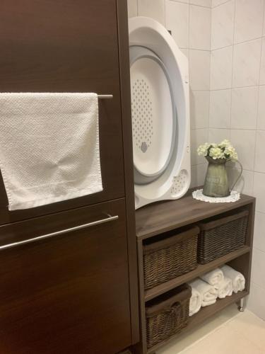 a washer and dryer in a cabinet in a bathroom at Lola Lakásapartman Nagykanizsa in Nagykanizsa