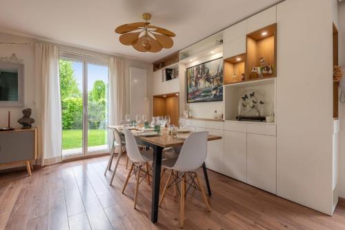 a dining room with a table and chairs at Villa Juliette - Welkeys in Écully
