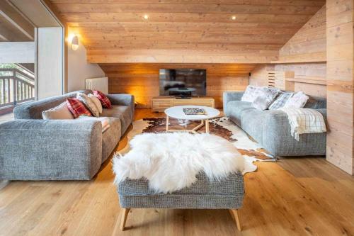 un salon avec deux canapés et une table dans l'établissement Etania 401 beautiful penthouse apartment in Meribel Morel, à Méribel