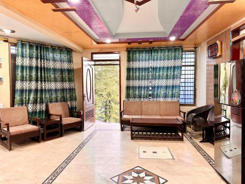 a waiting room with chairs and tables and curtains at Vacations In in Nathia Gali