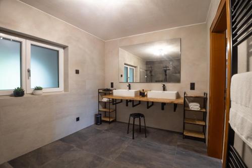 a bathroom with a sink and a large mirror at Jubiläum Apartment in Bad Ischl
