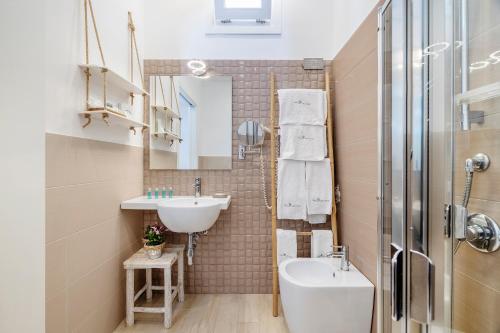 a small bathroom with a sink and a toilet at Hotel Soffio D'Estate in San Vito lo Capo