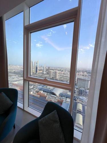 a view of a city from a large window at Cozy Stay in Manama