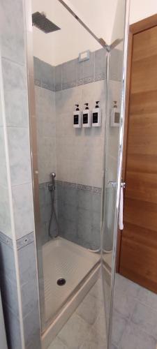 a shower with a glass door in a bathroom at Margot's House Rho in Rho