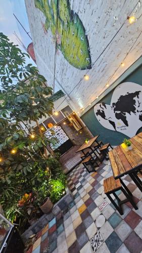a restaurant with a table and chairs and plants at Casa Columpio in Mexico City