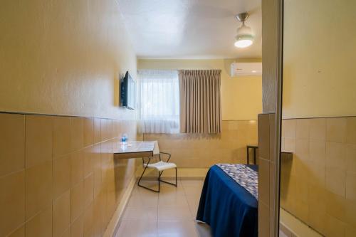 a hospital room with a table and a chair in it at Hotel Mazatlan in Mazatlán
