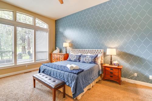 a bedroom with a bed and a blue wall at Redmond Golf Getaway - Near Smith Rock State Park! in Redmond