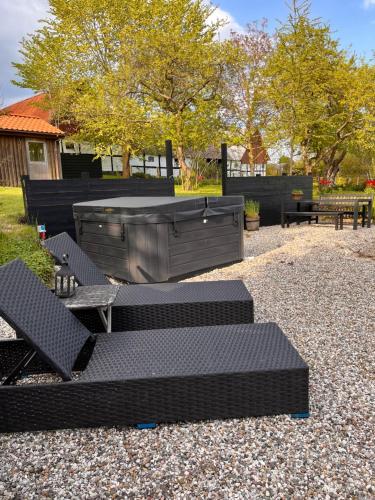 a group of chairs and tables in a park at Sofie's Hus - Munkgaard in Hårlev