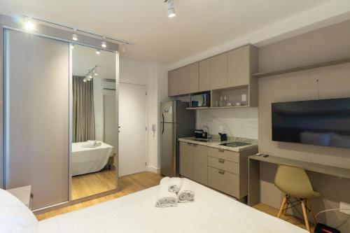 a room with a bathroom with a bed and a television at 360 Klabin in Sao Paulo