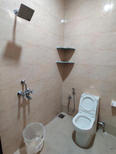 a bathroom with a toilet and a sink at Hotel MJ Beach Resort Baga in Baga